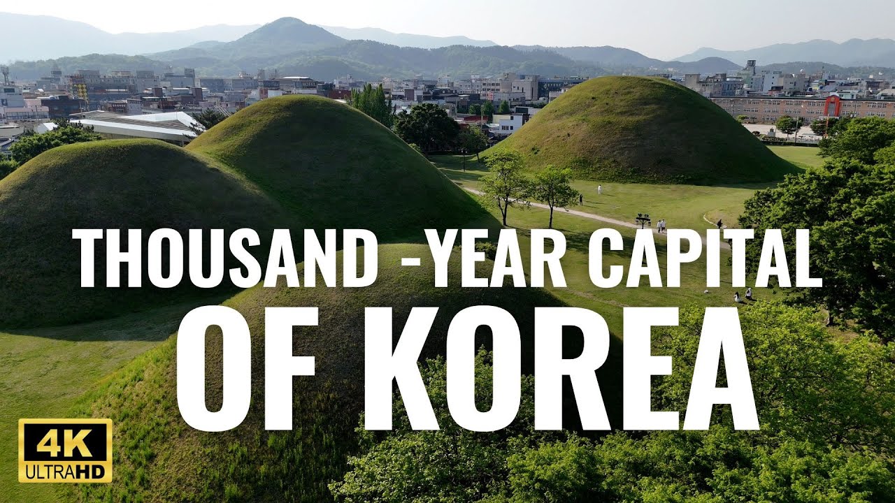 The Daereungwon royal tomb complex in Gyeongju showing the grass-covered hill burial mounds of Silla dynasty kings in a serene park setting