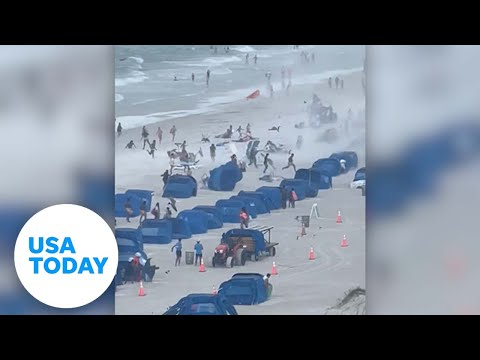 Cameras capture waterspout ripping through crowded beach | USA TODAY