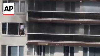 Dramatic video shows man escaping an apartment fire through a window in Belgium