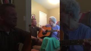 88-year-old woman with Alzheimer's sings and plays with her son.