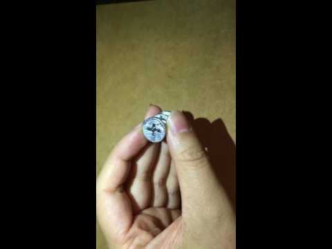 Part of a video titled How to remove a cam lock (C shaped) from Ikea furniture - YouTube