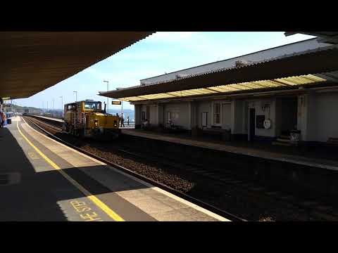 Trains.  A very unusual looking track maintenance machine passing along the Dawlish sea wall