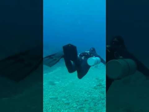 Scuba diver doing the frog kick and paddling