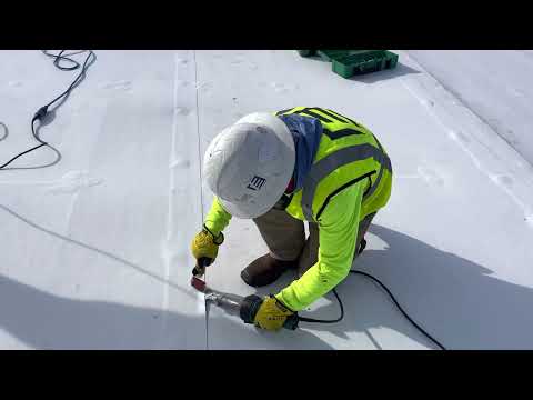 Using a Leister hand welder to seal seam of a TPO roof