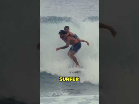 Surfing with his son on his back!❤️😲