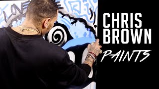 Chris Brown does spray paint art at HOT 97 studios?