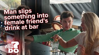 Young man spikes a woman’s drink at a bar
