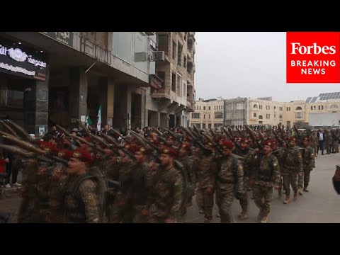 Thousands Of Syrian Soldiers March To Commemorate One-Year Anniversary Of Assad Regime's Fall
