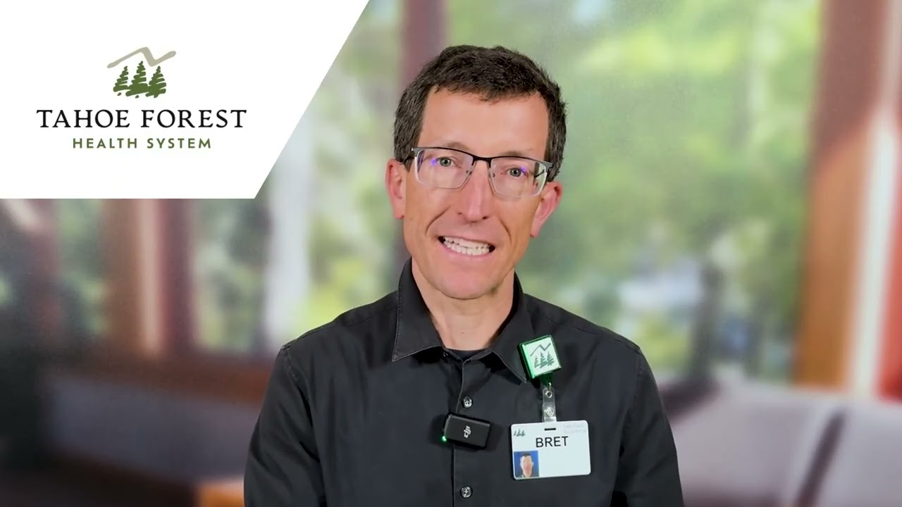 Bret Sarnquist, Outpatient Wellness Dietitian, sitting in front of a blurred window