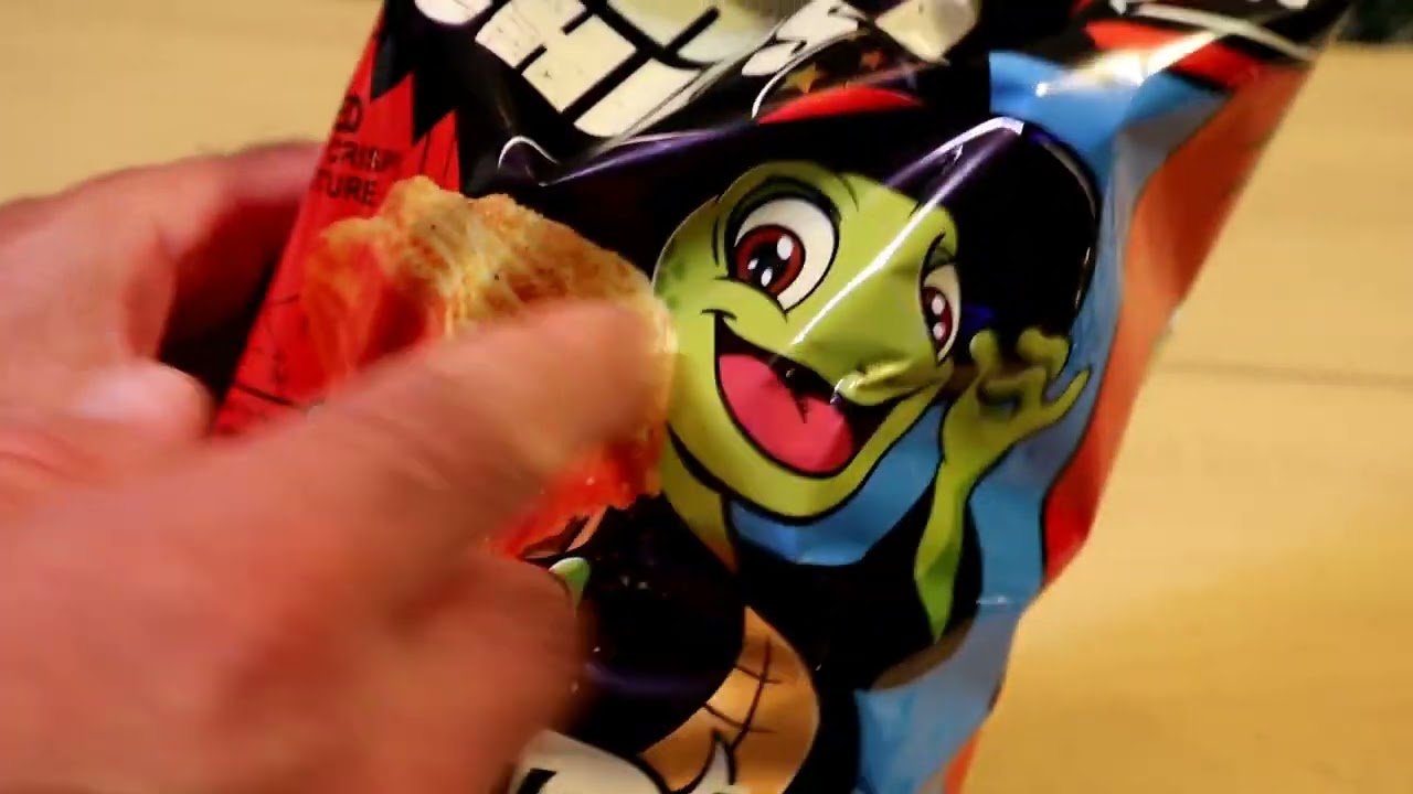 A bag of Orion Turtle Chips Spicy Flamin Lime four layer Korean snack opened with the bright green packaging and spicy lime seasoning visible