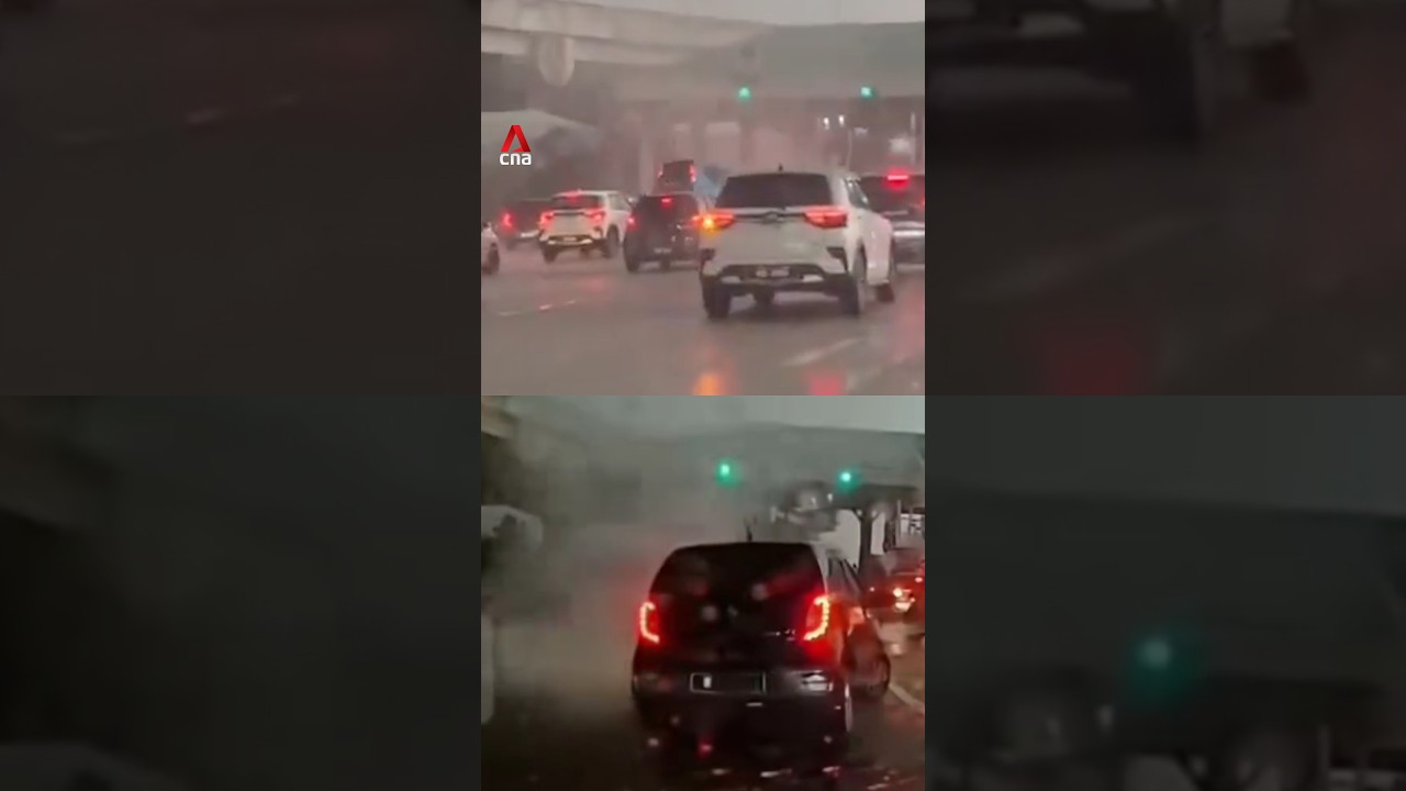 Strong winds lift vehicles at Malaysian toll plaza during thunderstorm, car lands on another vehicle