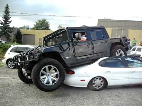 Hummer H1 open top stuck on a ford taurus