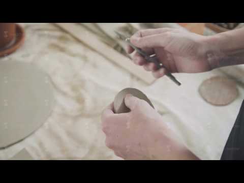 Close-up of a master potter, clay cutting special tool. Chisel for clay