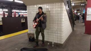 Effortless guitar player in New York City Subway
