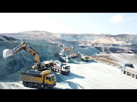 Caterpillar 385C And Liebherr 974 Excavators Loading Trucks