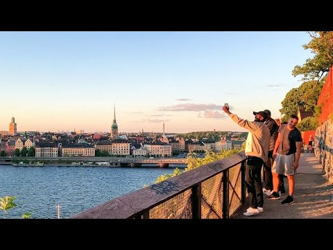 Stockholm Walks on Midsummer´s Eve. Sunset, city view and happy people on Monteliusvägen, Södermalm