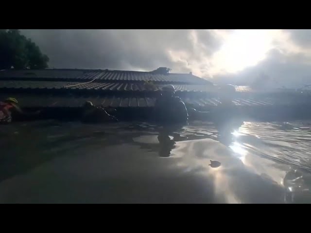 Rescue workers search for survivors through the night