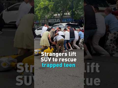 Strangers lift SUV to rescue trapped teen
