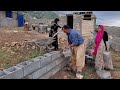 Looking for peace: Razia and her family building a yard for their house.