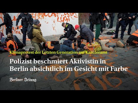 Berliner Polizist beschmiert Klima-Aktivistin in Berlin absichtlich im Gesicht mit Farbe