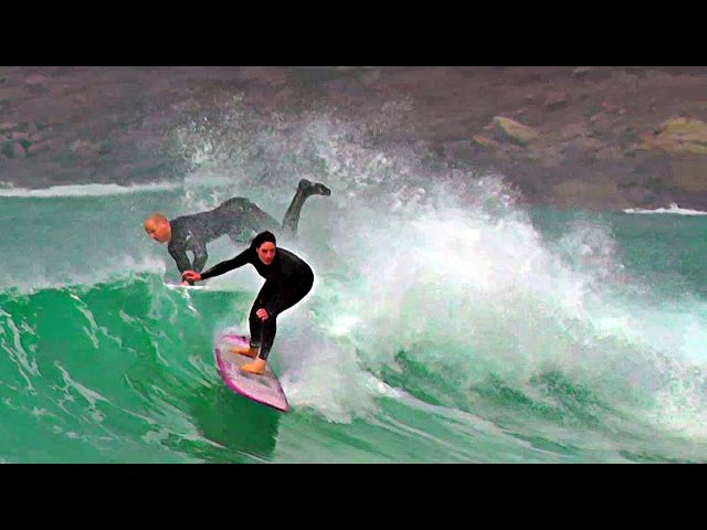 Surfing at Sennen Cove in Cornwall UK