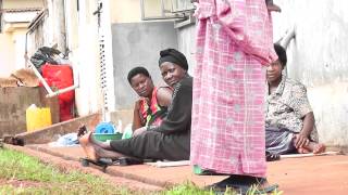 African Mothers and babies sit on the ground waiting fora chance at the free treatment.