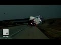 Massive tornado destroys buildings, flips semi-trucks.
