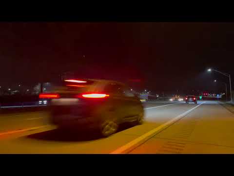 Cars and trucks passing by on the road at night