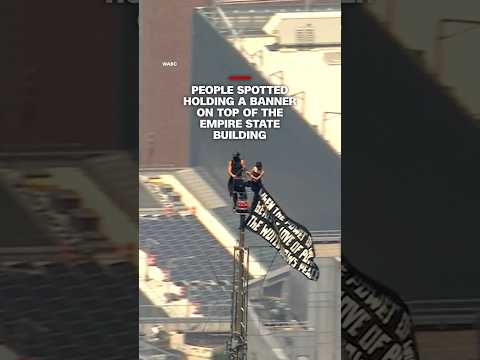 People spotted holding a banner on top of the Empire State building