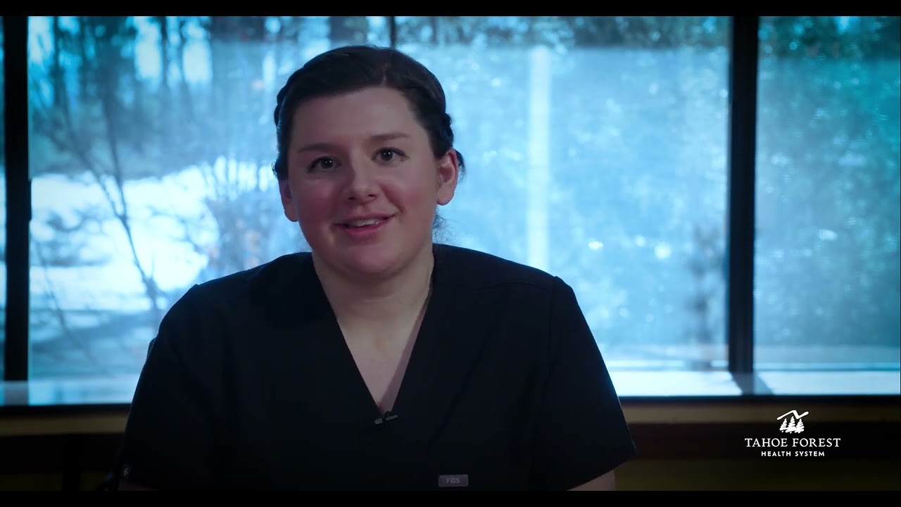 Kari Rezac, Sports Medicine Physician and Director of Sports Medicine, sitting in front of a window