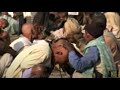An Old Indian Devotee Has His Head Shaved During The Kumbh Mela