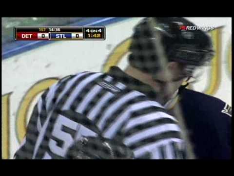 hossa gets hit after a shot and goes head first in the boards