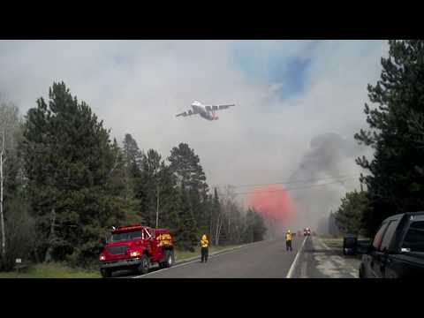 Water bomber stops fire at road