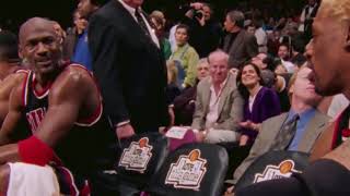 Michael jordan and dennis rodman talking strategy on the bench