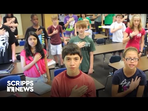 Why do US students pledge allegiance to the flag?