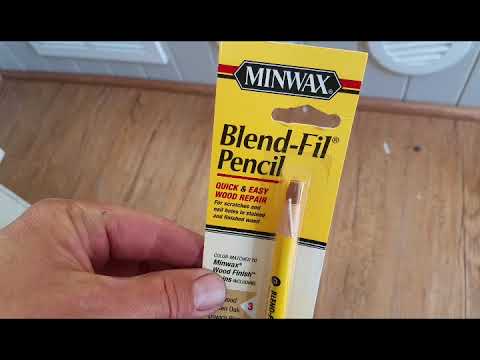 Laminate floor scratch repair in travel trailer.