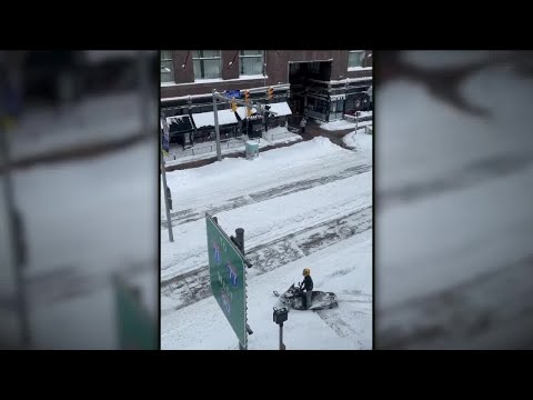 Snowmobile flying down Euclid Ave. symbolizes how ridiculous this snowstorm has been