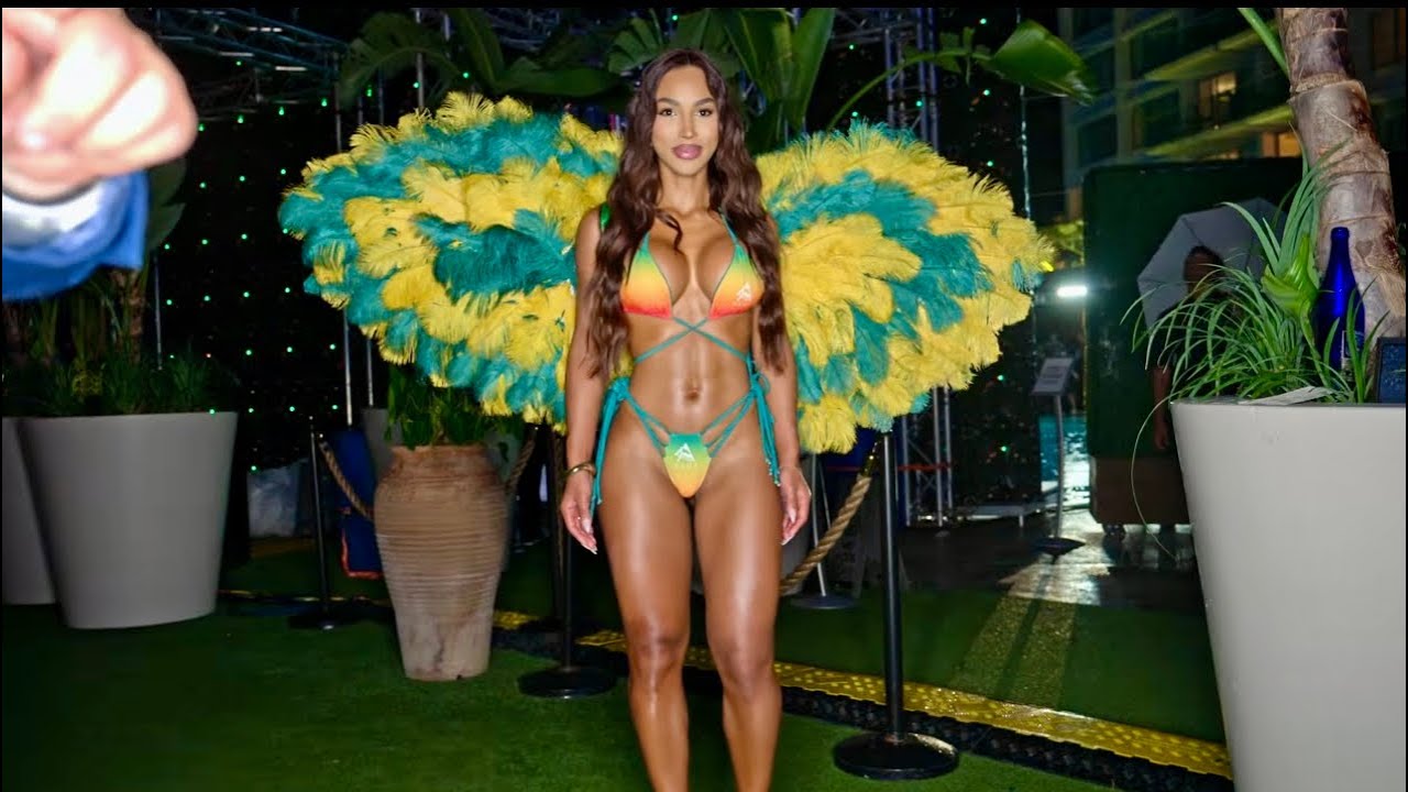 Model Virginia Sanhouse poses backstage at Miami Swim Week The Shows wearing Brazilian colored wings