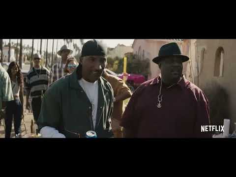 Trailer image: flashing police lights wash the street in red-blue as characters brace for another round