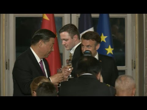 Macron and Xi toast at a state dinner at the Elysee Palace | AFP
