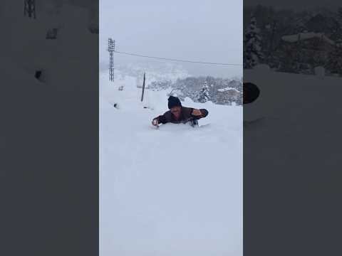 The snow is almost about to swallow the man.