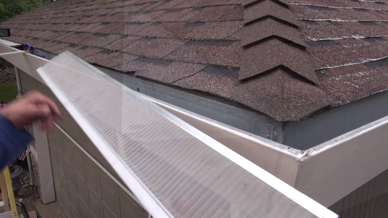 Installing gutter guards on an asphalt shingle roof