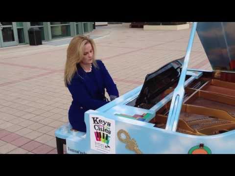 Dr. Robin Arrigo performs on a Keys to the Cities piano