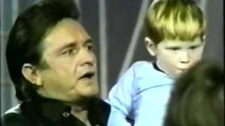 Johnny Cash sings "Jesus Loves Me" to children