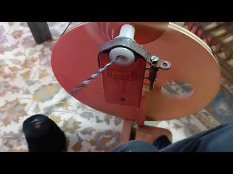 Weaving table runner : Plying three yarns together to make one.