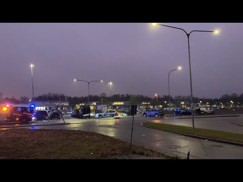 Police vehicles outside Swedish school after five people wounded in shooting | AFP