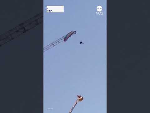 Paraglider gets caught on giant construction crane in China