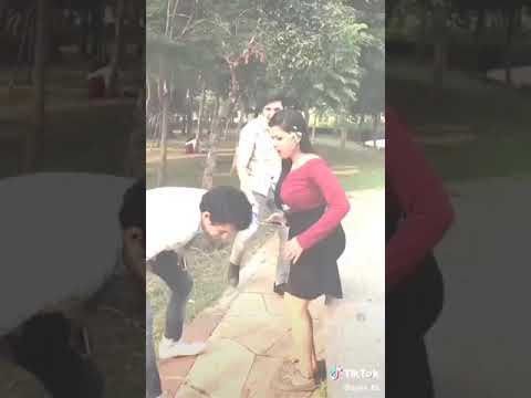 A girl kicks a boy in the centre