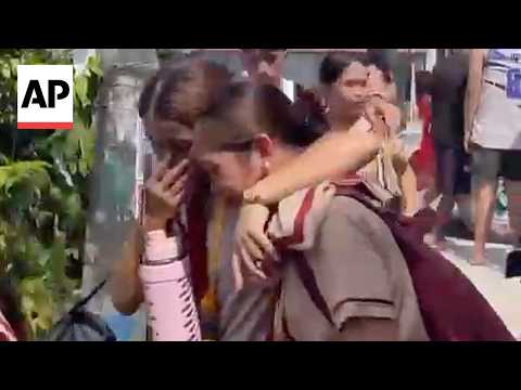Students cry and hug each other after school shooting in the Philippines