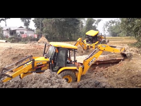 Two JCBs Demolishing An Old Bridge In The Village / JCB Dozer Out Throwing Slabs